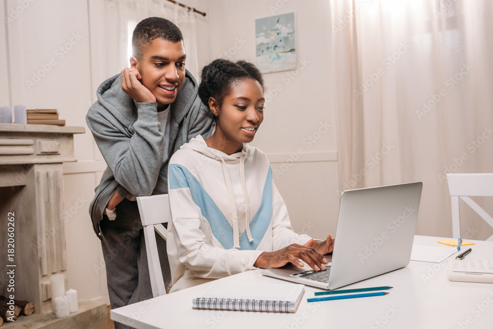 african american couple using laptop african american couple using laptop