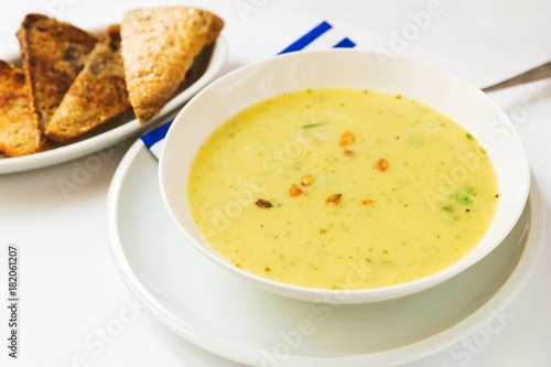 Dense vegetable soup on white background.
