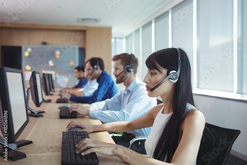 Businesswoman typing on keyboard at call center