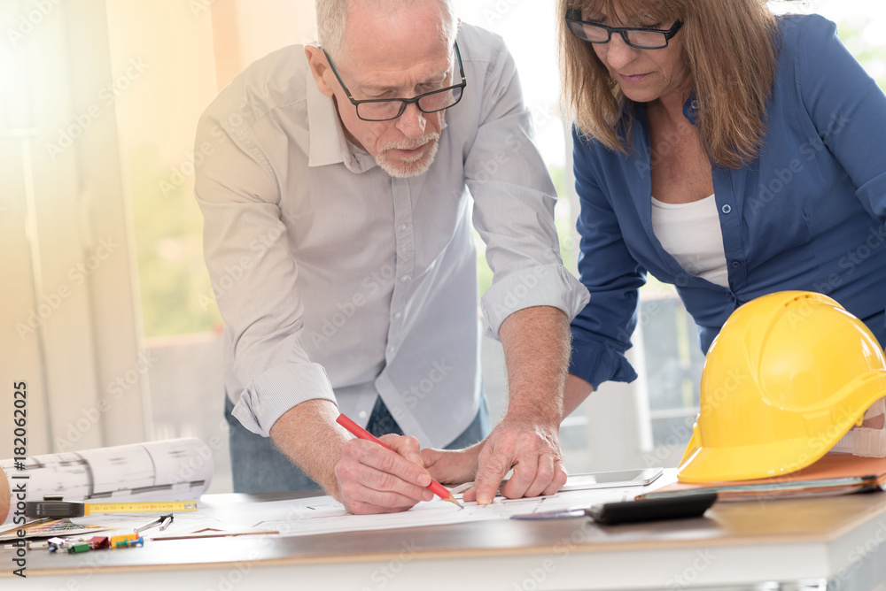 Obraz premium Architects working on plans, light effect