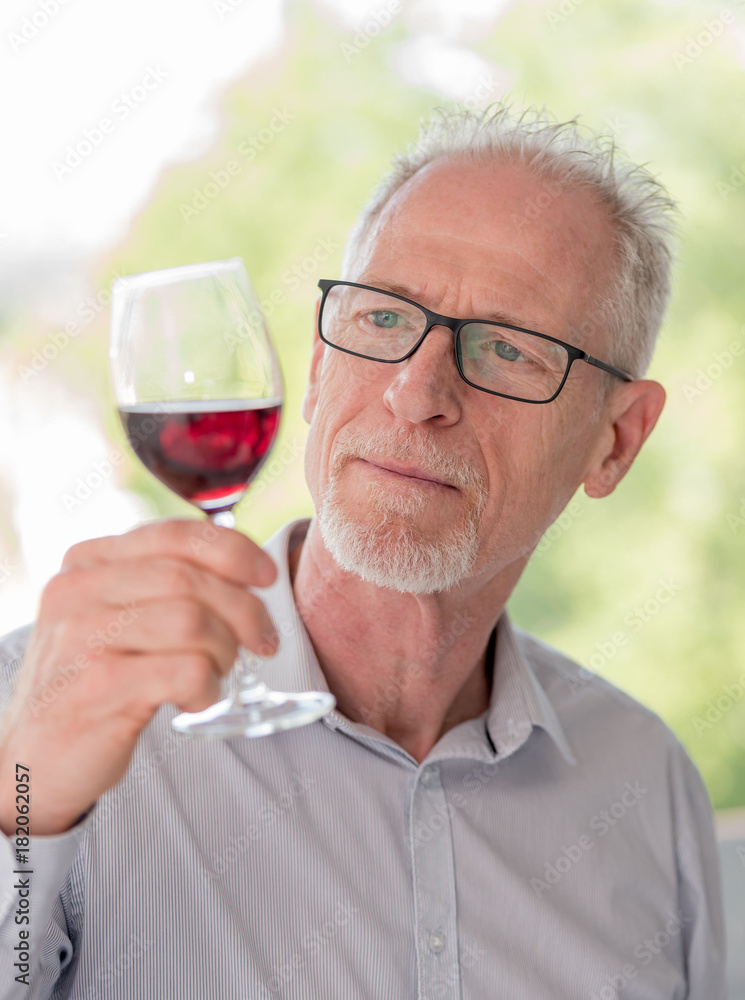Mature man tasting red wine Mature man tasting red wine