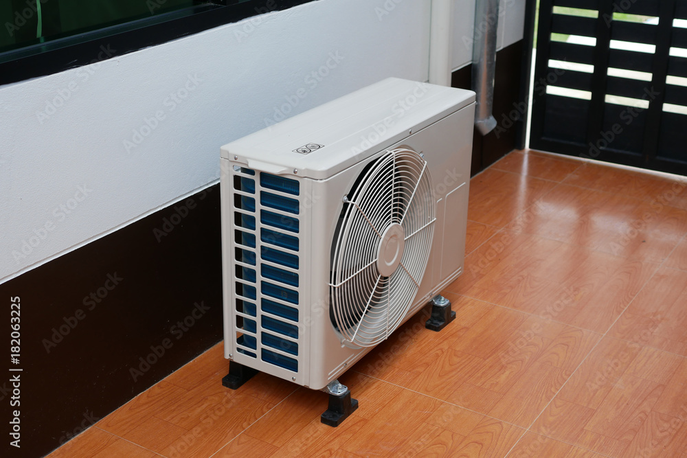 Air conditioner condenser unit on a floor Air conditioner condenser unit on a floor