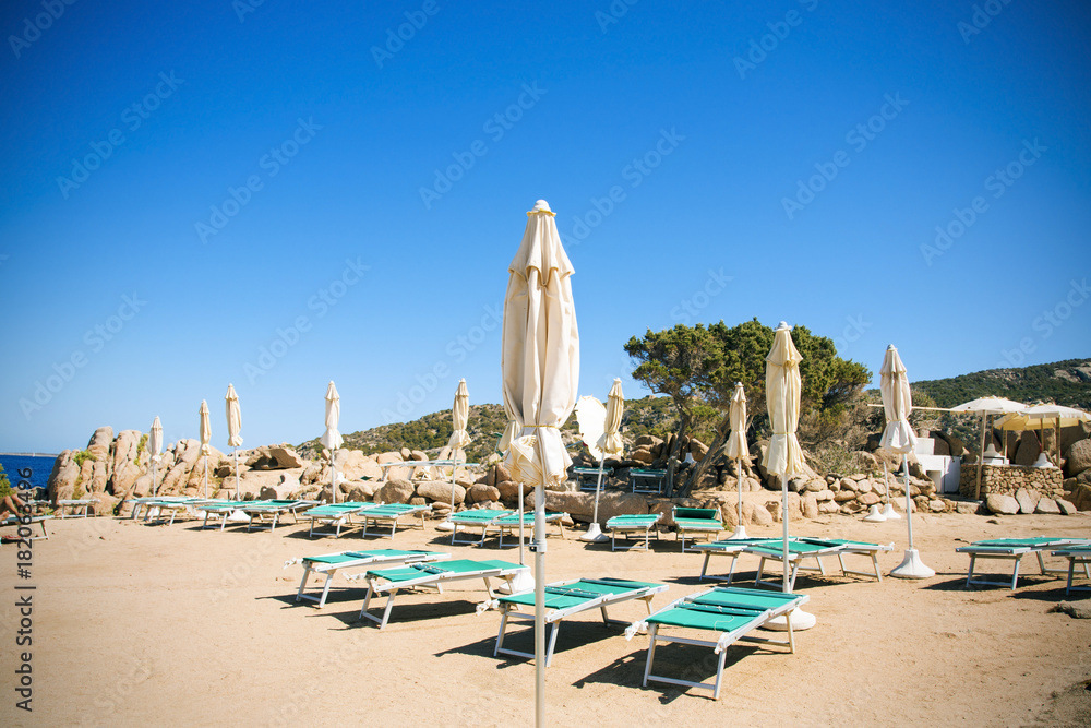 sunloungers and umbrellas in Baja Sardinia, Italy