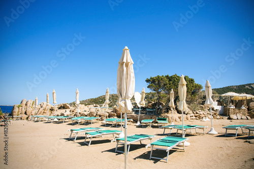 sunloungers and umbrellas in Baja Sardinia, Italy © nito