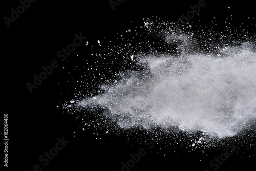 Fototapeta Naklejka Na Ścianę i Meble -  Freeze motion of white powder explosions isolated on black background.