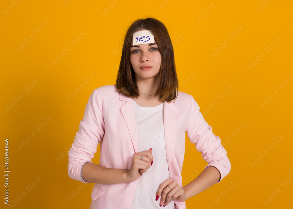 Obraz premium Young cute girl, sticker on a head, studio