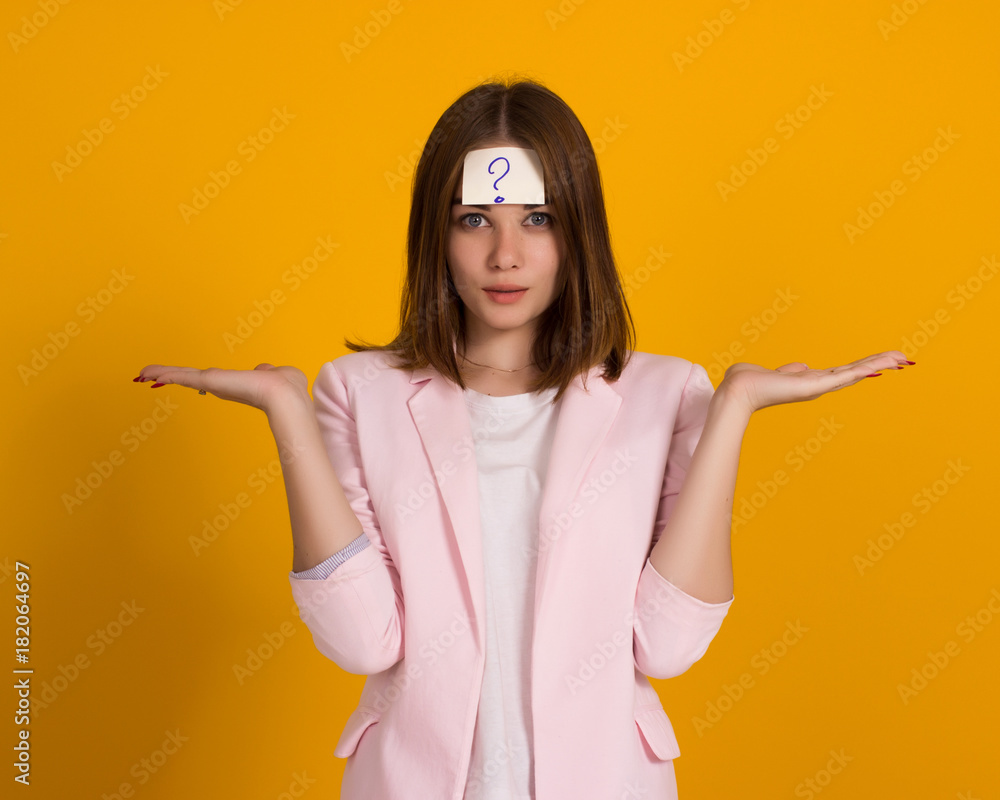 Young cute girl, sticker on a head, studio Young cute girl, sticker on a head, studio