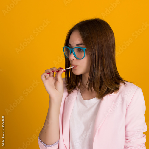 Young cute girl chews bubble gum, isolated  