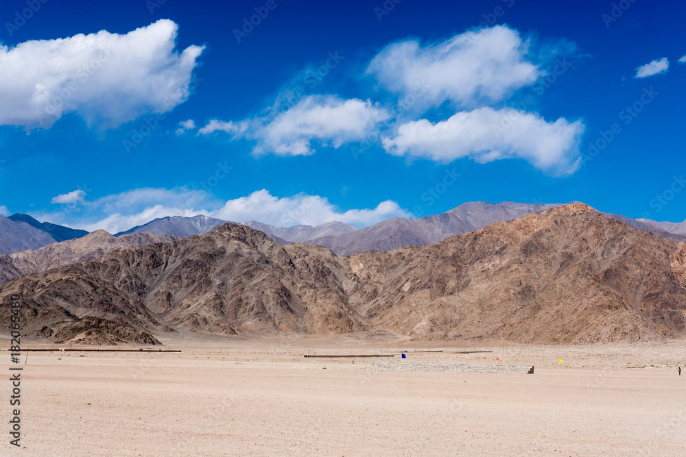 Landscape image of desert , mountains and blue sky background in Ladakh , India
