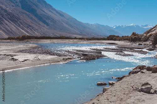 Landscape image of the blue Shyok river on the way to Nubra valley with mountain and blue sky background   Ladakh India