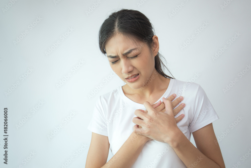 Woman touching her chest with hands. Young asian woman feel pain in her chest . Isolated on white background. Woman touching her chest with hands. Young asian woman feel pain in her chest . Isolated on white background.
