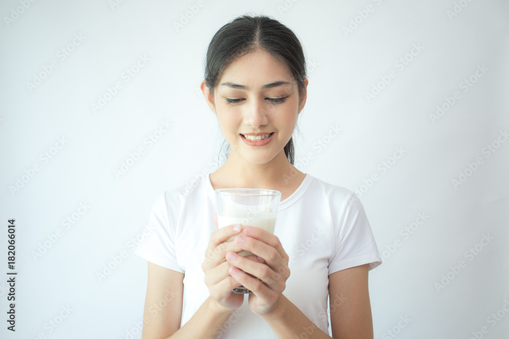 Young Asian Woman holding milk with smile on white background. Young Asian Woman holding milk with smile on white background.