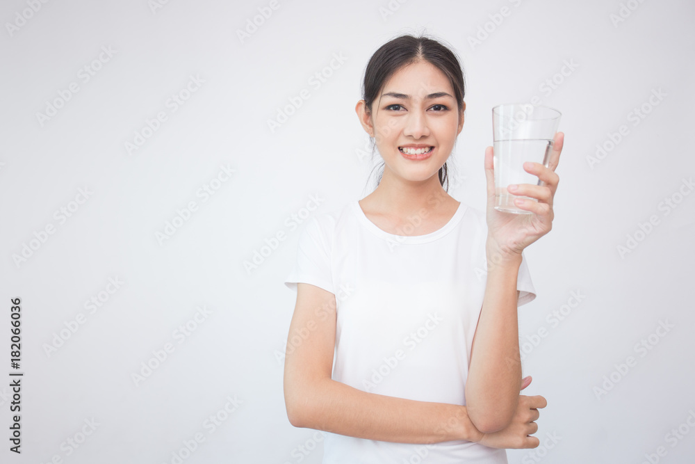 Young Asian Woman holding water with smile on white background. Young Asian Woman holding water with smile on white background.