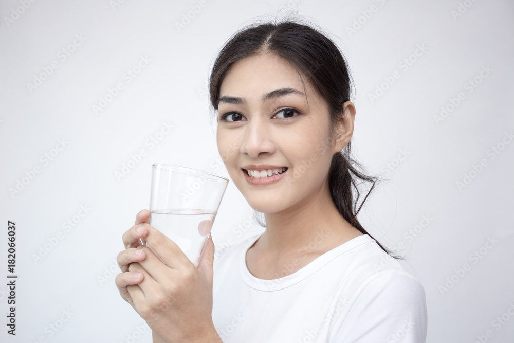 Young Asian Woman holding water with smile on white background. Young Asian Woman holding water with smile on white background.