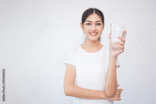 Young Asian Woman holding water with smile on white background.