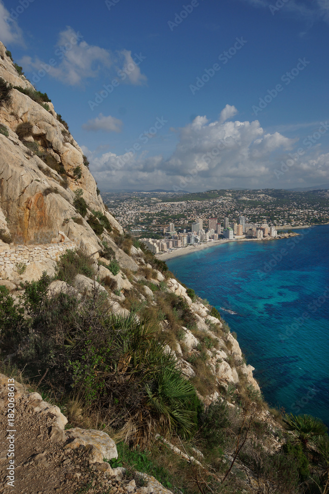 View of the steep mountainside and the coast of the Mediterranean city of Calp in Spain, the Costa Blanca region