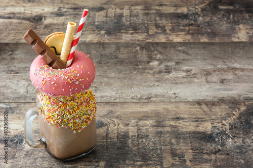 Quadro em tela Extreme milkshake or freak shake on wooden table. Copyspace