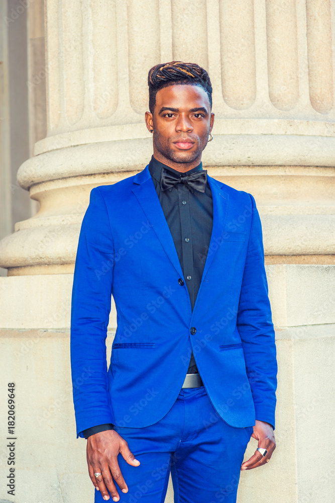 African American Man Fashion in New York. Dressing formally in blue suit, black  shirt, bow tie,