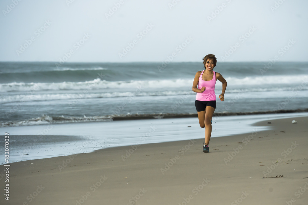 young attractive and fit Asian sport runner woman running on beach sea side smiling happy in fitness young attractive and fit Asian sport runner woman running on beach sea side smiling happy in fitness