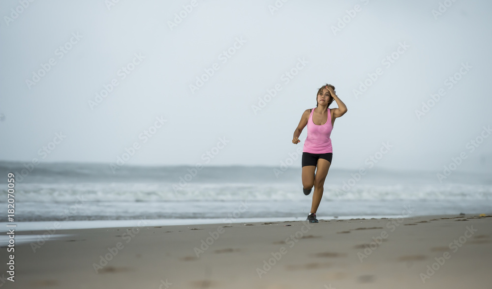 young attractive and fit Asian sport runner woman running on beach sea side smiling happy in fitness young attractive and fit Asian sport runner woman running on beach sea side smiling happy in fitness