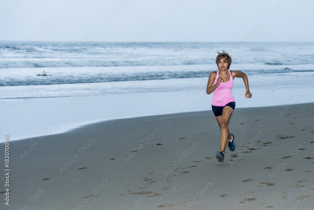 young attractive and fit Asian sport runner woman running on beach sea side smiling happy in fitness young attractive and fit Asian sport runner woman running on beach sea side smiling happy in fitness