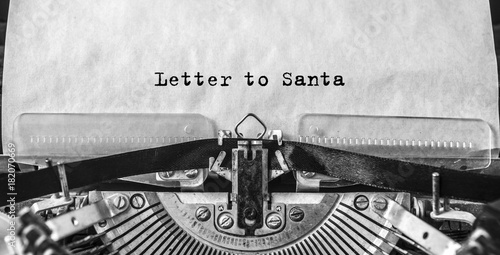 Letter to Santa printed on an old vintage typewriter, close-up. Letter to Santa Claus with wishes for gifts, Christmas, New Year.