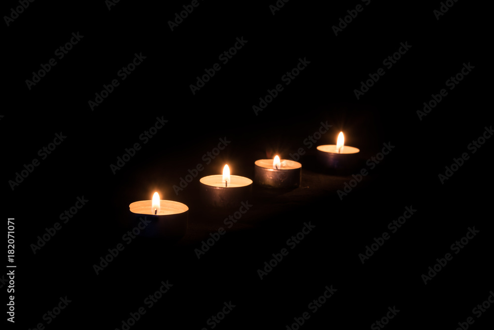Fototapeta premium Burning candles against black background