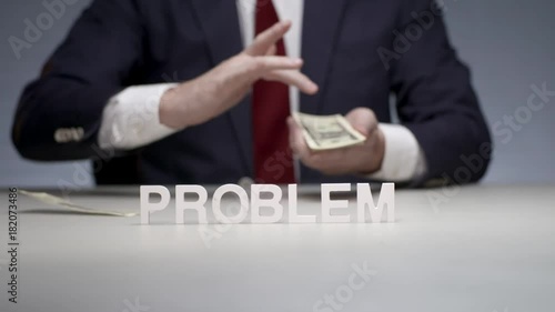 Word problem from letters on background man hands irrational spending money photo