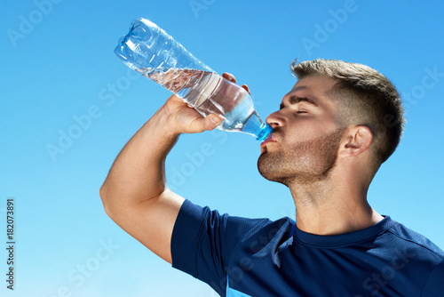 Man Drinking Water After Running. Portrait.