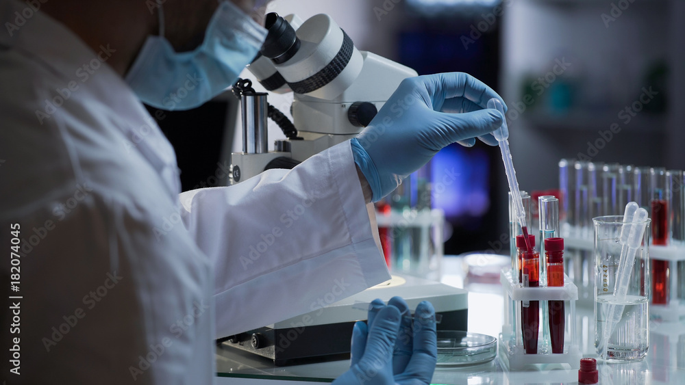 Laboratory assistant taking drop of blood to detect antibodies and infections Laboratory assistant taking drop of blood to detect antibodies and infections