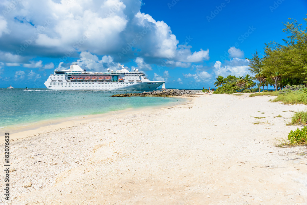 Cruise ship on Caribbean Sea close to paradise beach. Tropical travel concept and destination for vacation. Recreation and relaxing. Cruise ship on Caribbean Sea close to paradise beach. Tropical travel concept and destination for vacation. Recreation and relaxing.