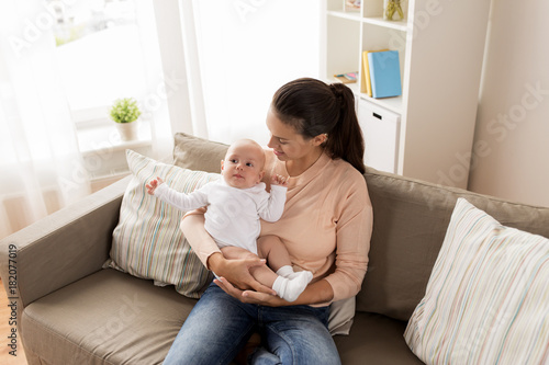 happy mother with little baby boy at home