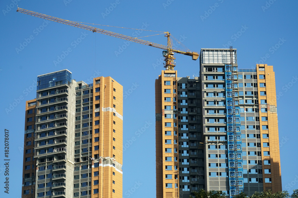 skyscraper building under construction with crane at construction site skyscraper building under construction with crane at construction site