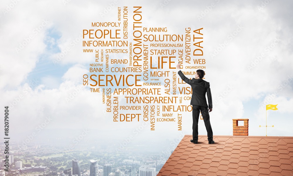 Young businessman standing on house roof and writing leadership skill concept. Mixed media Young businessman standing on house roof and writing leadership skill concept. Mixed media