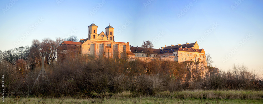 Tyniec near Krakow, Poland. Benedictine abbey on the rocky cliff in late fall  Wide panorama in sunset light