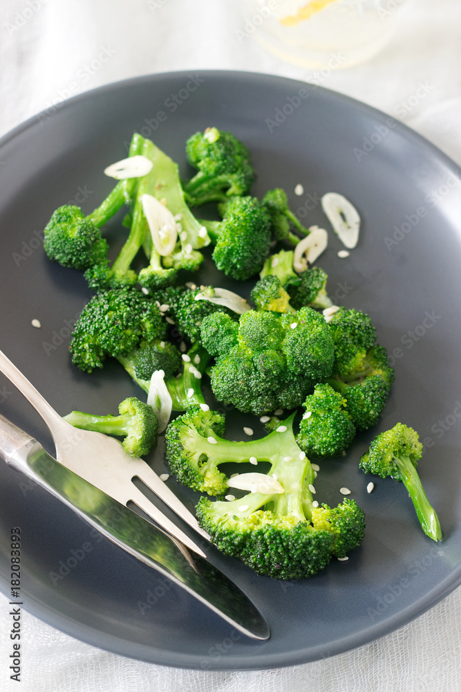 Broccoli cooked with garlic, ginger and sesame served with lemonade. Rustic style. Broccoli cooked with garlic, ginger and sesame served with lemonade. Rustic style.