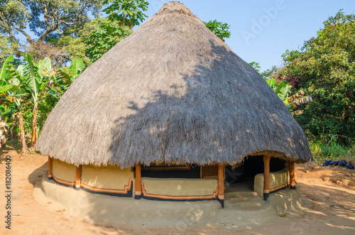 Beautiful and colorful traditional thatched round mud and clay hut in rural village of Guinea Bissau, West Africa photo