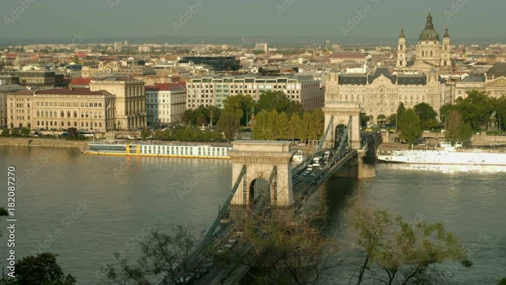 Camera rises to reveal cars passing over Chain Bridge in Budapest. Shot on sunny autumn afternoon Camera rises to reveal cars passing over Chain Bridge in Budapest. Shot on sunny autumn afternoon