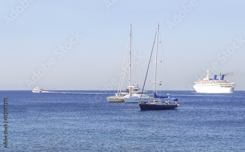 Several boats on the blue clean natural sea for transportation or vacation