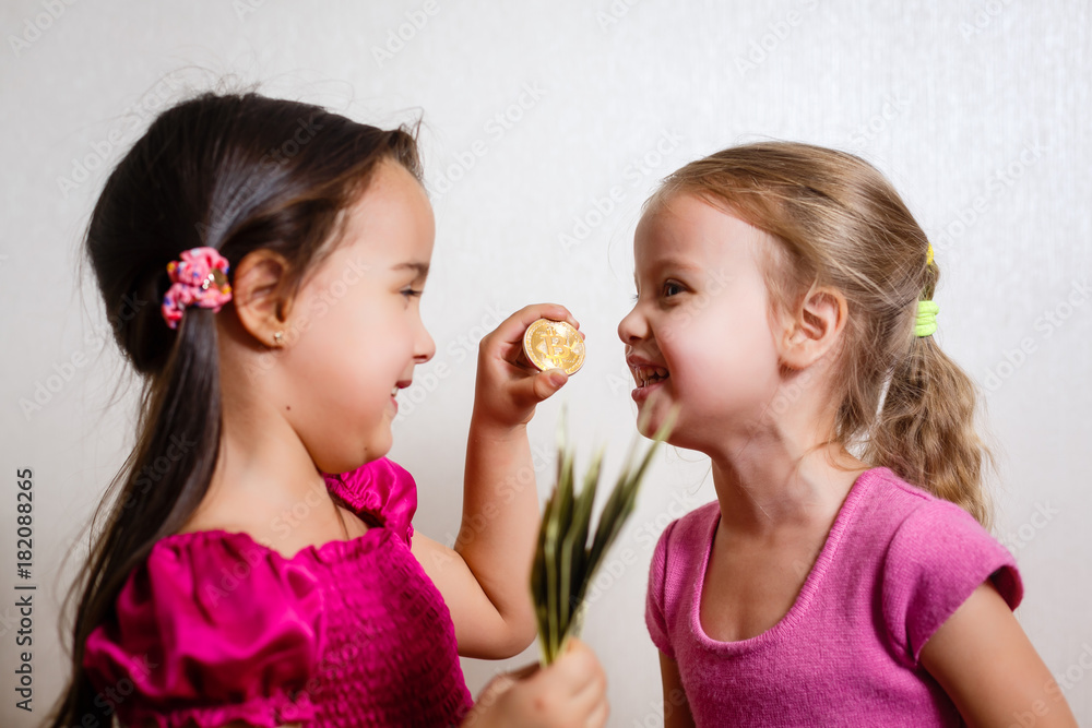 two little girls with dollars and bitcoin on white background two little girls with dollars and bitcoin on white background