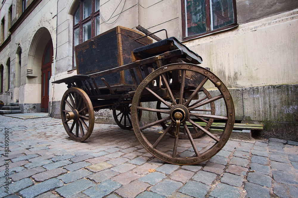 Vintage wooden cart on a cobble stone street in an old town