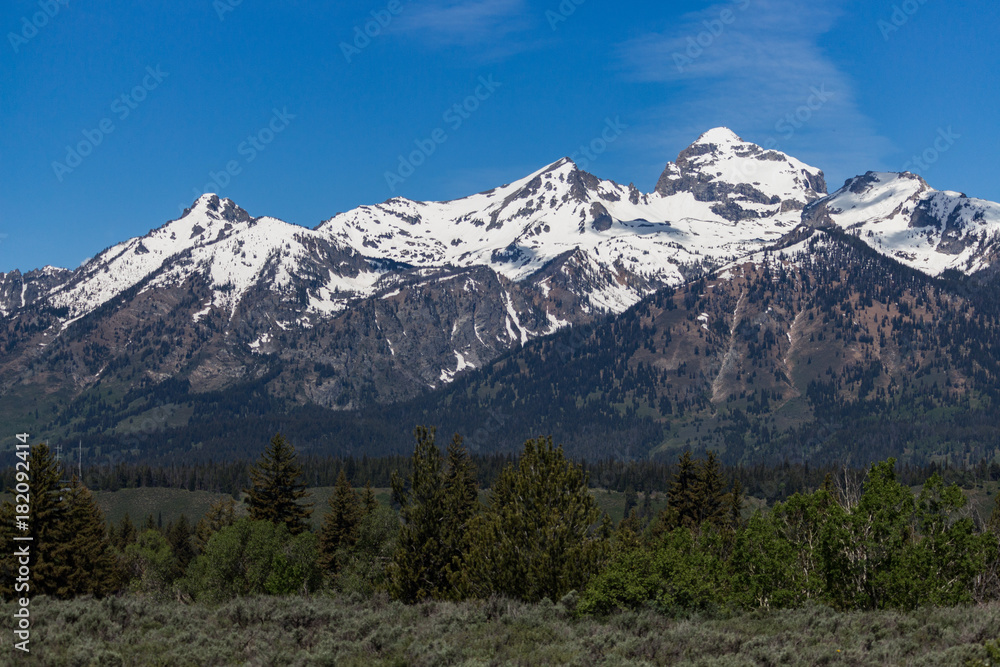 Grand Teton Mountain Range with blue sky and clouds