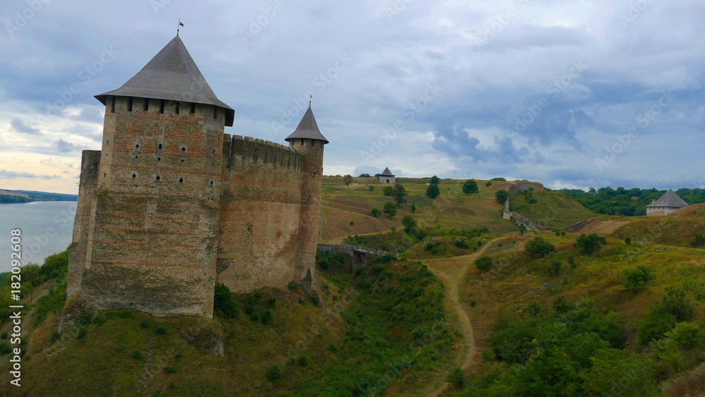 Khotyn castle in Ukraine is a powerful medieval fortress that witnessed the fighting between Poles, Cossacks and Turks. High medieval walls, towers on the background of the picturesque Dniester. Khotyn castle in Ukraine is a powerful medieval fortress that witnessed the fighting between Poles, Cossacks and Turks. High medieval walls, towers on the background of the picturesque Dniester.