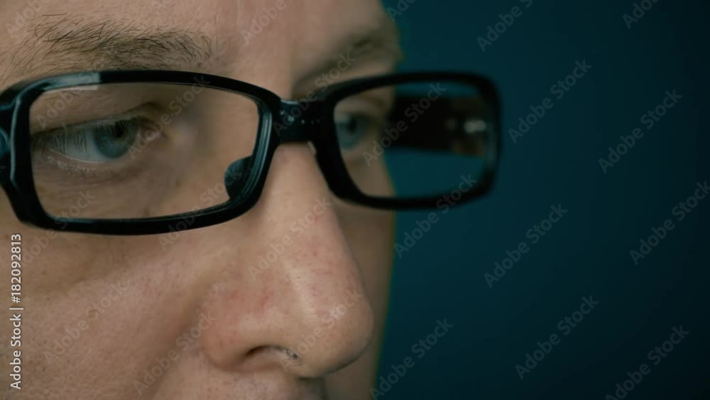 Half-turned portrait of adult caucasian man in fashion glasses. Extreme close up male face. Man read book pc messages blog site game internet. Half-turned portrait of adult caucasian man in fashion glasses. Extreme close up male face. Man read book pc messages blog site game internet.