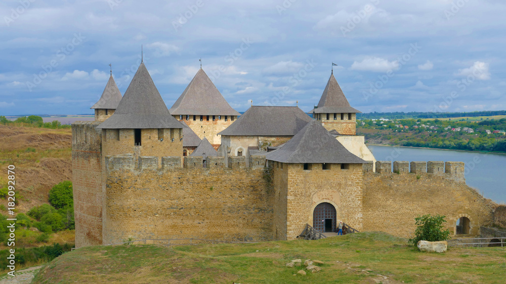 Khotyn castle in Ukraine is a powerful medieval fortress that witnessed the fighting between Poles, Cossacks and Turks. High medieval walls, towers on the background of the picturesque Dniester. Khotyn castle in Ukraine is a powerful medieval fortress that witnessed the fighting between Poles, Cossacks and Turks. High medieval walls, towers on the background of the picturesque Dniester.
