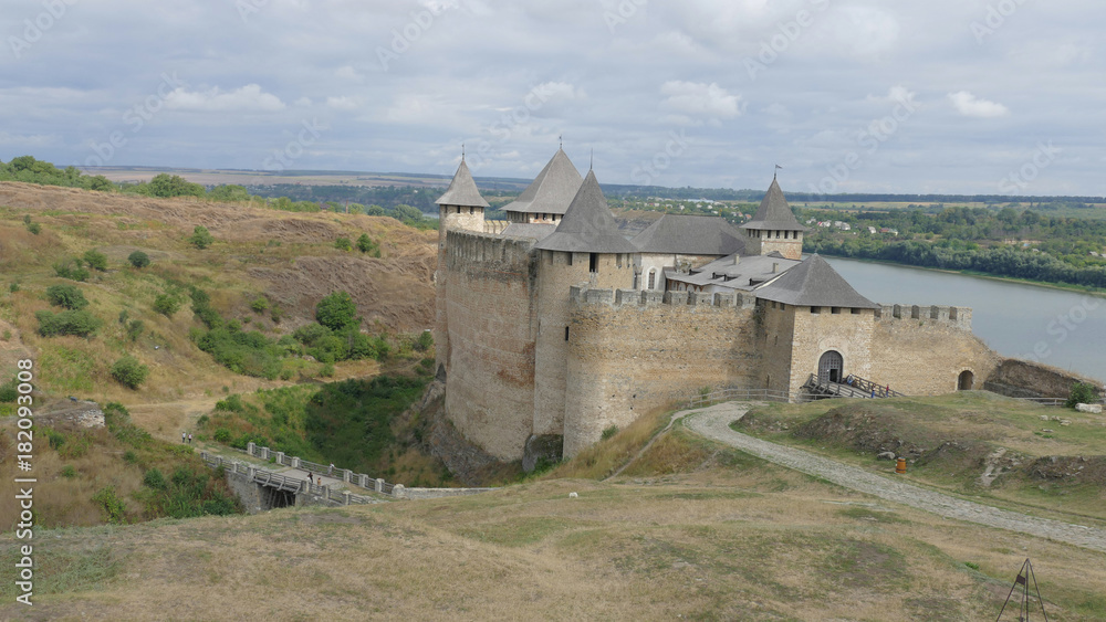 Khotyn castle in Ukraine is a powerful medieval fortress that witnessed the fighting between Poles, Cossacks and Turks. High medieval walls, towers on the background of the picturesque Dniester. Khotyn castle in Ukraine is a powerful medieval fortress that witnessed the fighting between Poles, Cossacks and Turks. High medieval walls, towers on the background of the picturesque Dniester.