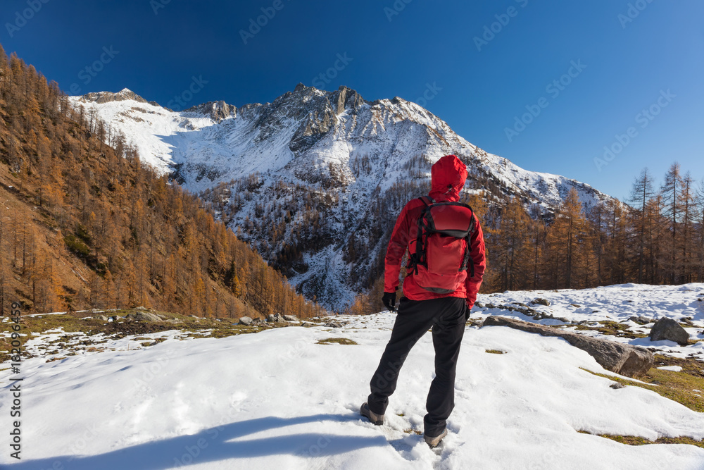 Man is backpacking in winter mountains. Piemonte, Italian Alps, Europe.