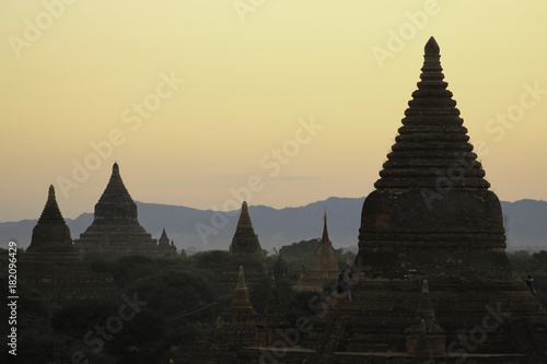 Dusk Silhouette of Temples of Bagan  Myanmar among hazy orange sky. No Balloons in Sight  only a few tourists. A perfect evening.