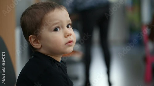 Small boy sitting in the waiting room in hospital

