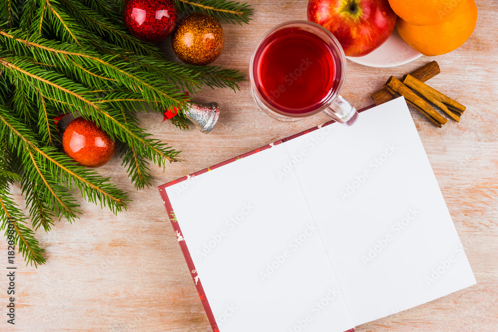 Christmas punch, fruit, branch of a Christmas tree with toys on a rustic wooden background and a gift book - copy space Christmas punch, fruit, branch of a Christmas tree with toys on a rustic wooden background and a gift book - copy space